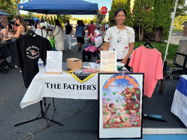 The Father's Love outreach table at a local community event